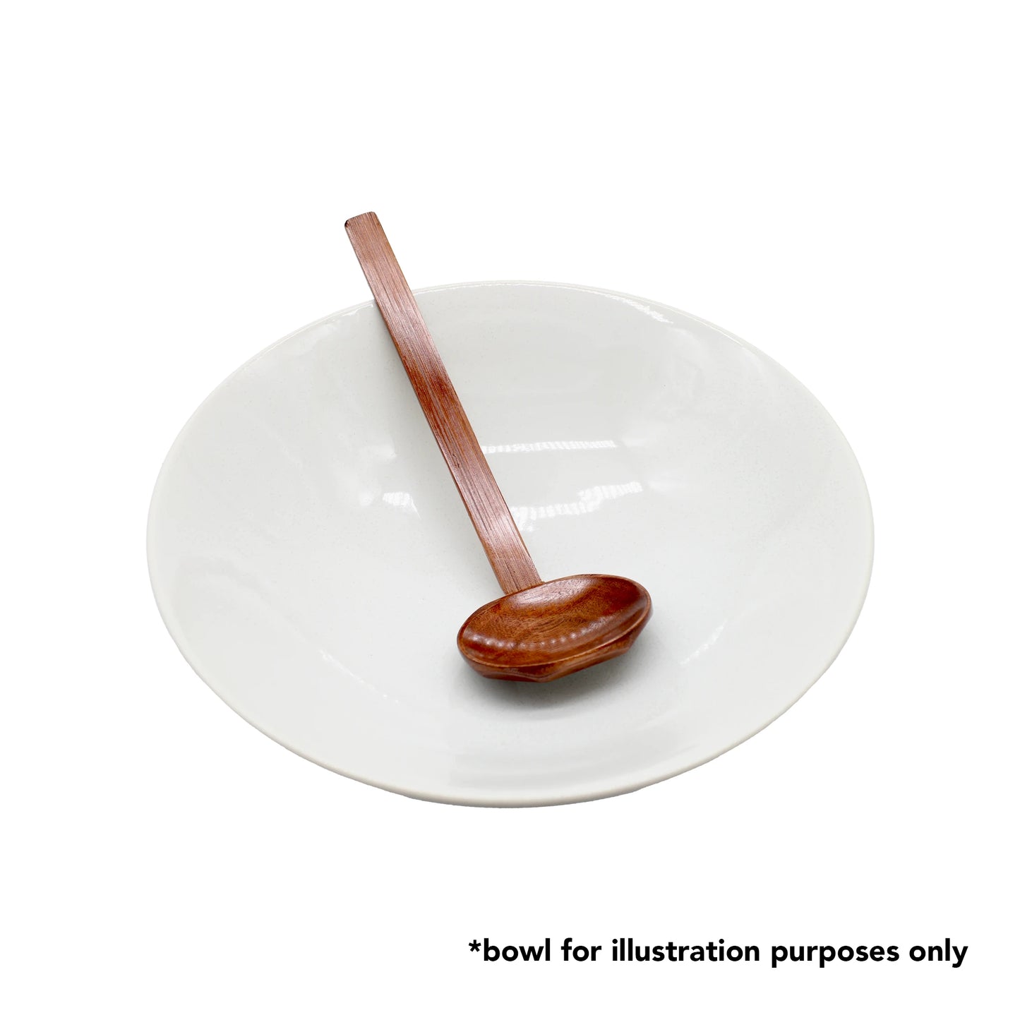 A Bamboo Ramen Spoon rests inside a plain white bowl on a white background, ideal for enjoying noodle soups; text at the bottom states, *bowl for illustration purposes only.