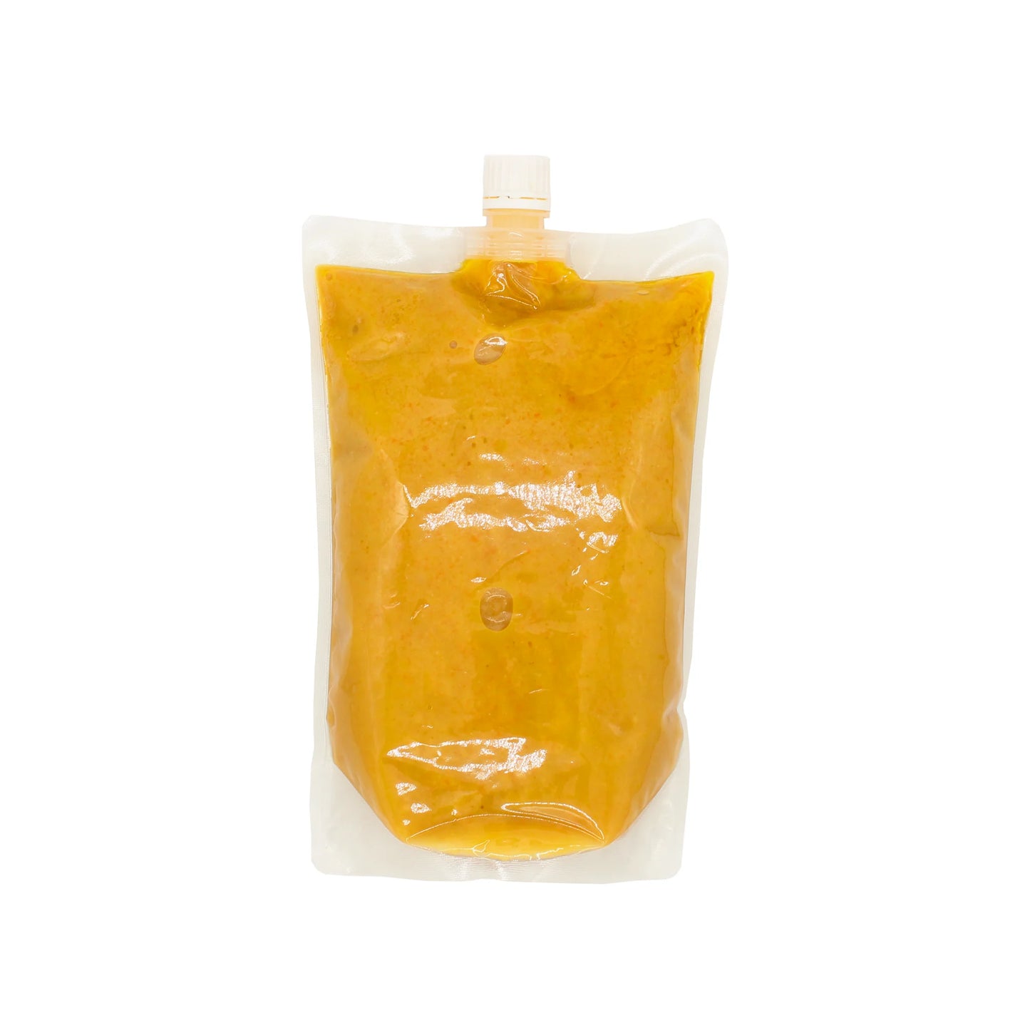 Carrot and Rice Koji Dressing, in a clear plastic pouch with an orange-yellow hue and white screw cap, features the umami flavor of koji rice against a clean white background.