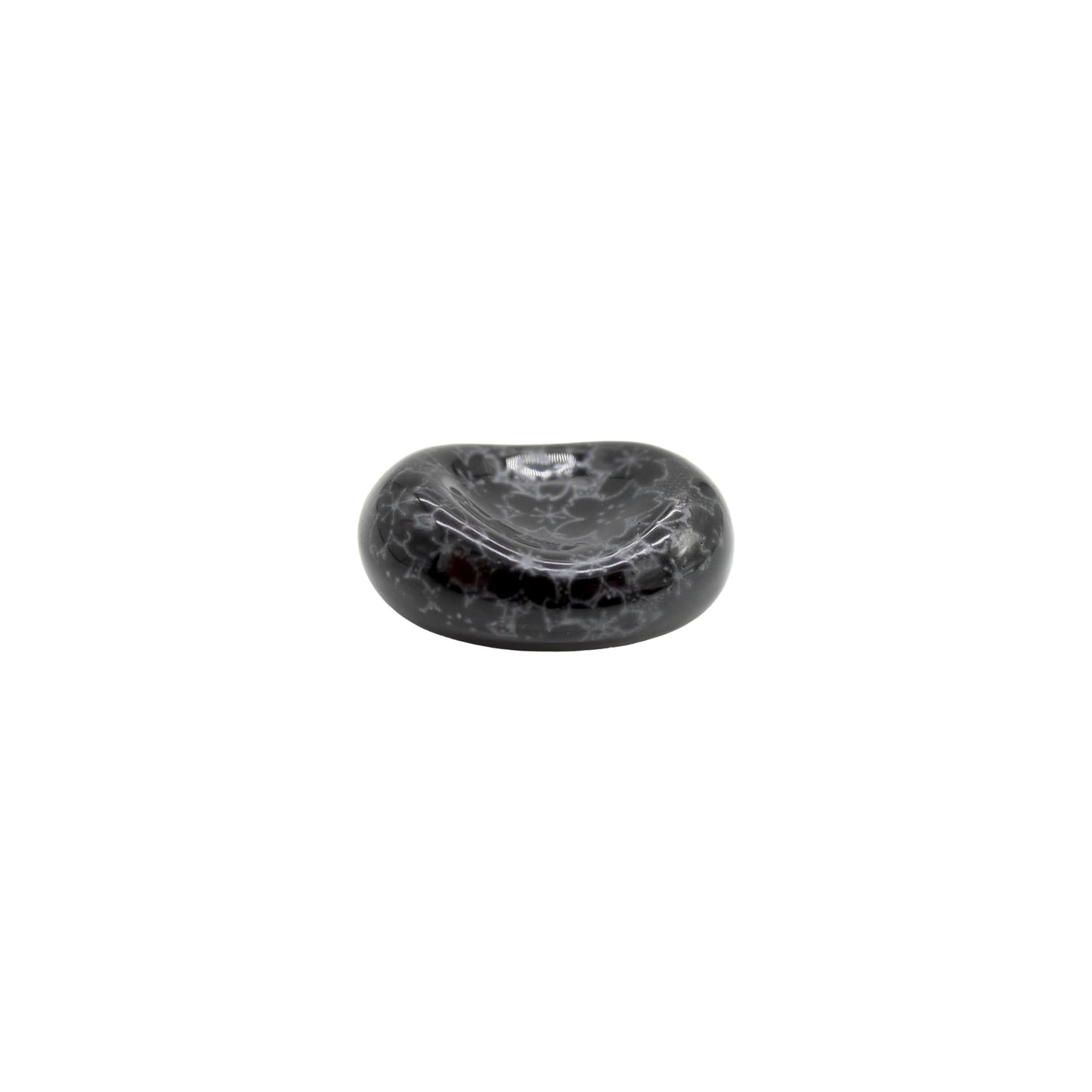 The Chopstick Rest - Pebble Black Sakura is a small, round Minoyaki porcelain rest featuring a black and gray marbled finish and a shallow top indentation, shown isolated on a white background.