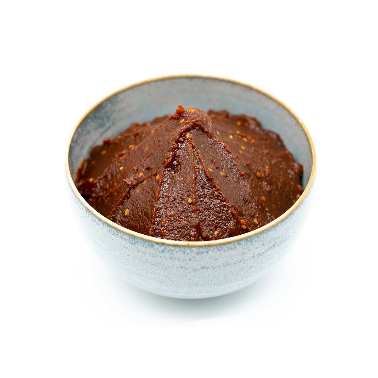 A gray ceramic bowl filled with a mound of Dare Miso, known for its rich umami flavor, isolated on a white background.