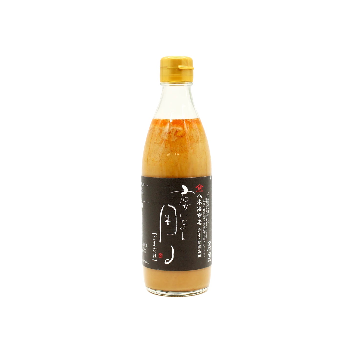 Gomadare Sesame & Dashi Sauce comes in a glass bottle with a yellow cap and Japanese text on a black label; its brownish, umami-rich liquid is perfect for enhancing Japanese cuisine.