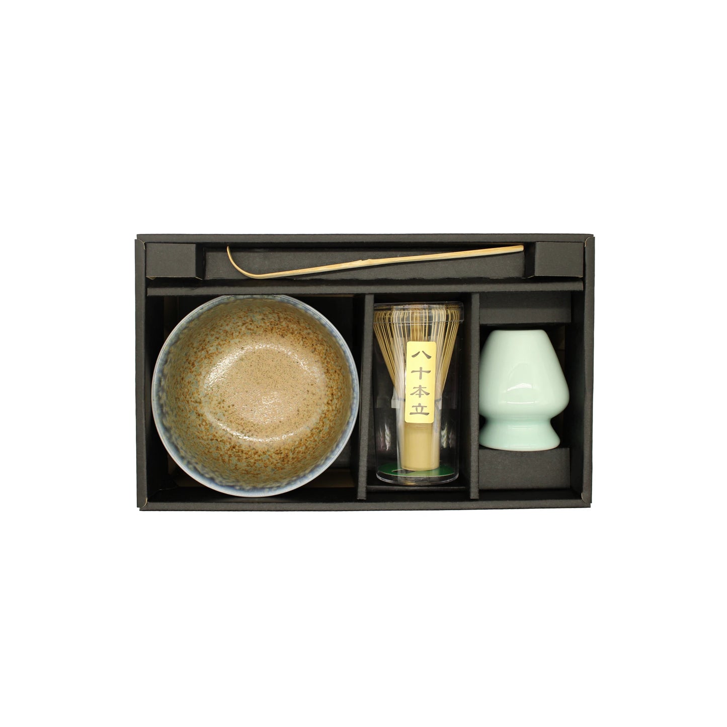 The Matcha Tea Set - Blue & Brown comes in a box with a ceramic bowl, bamboo whisk, scoop, whisk holder, and cup, each arranged in separate compartments.