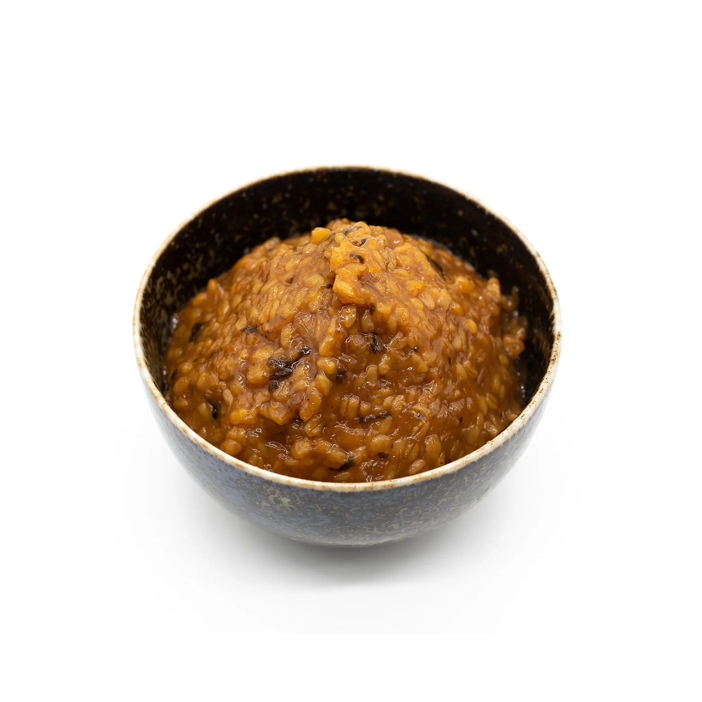 A black bowl holds Oname Plum Miso, a miso paste crafted from fermented soybeans and plums, delivering a rich umami flavor against a white background.