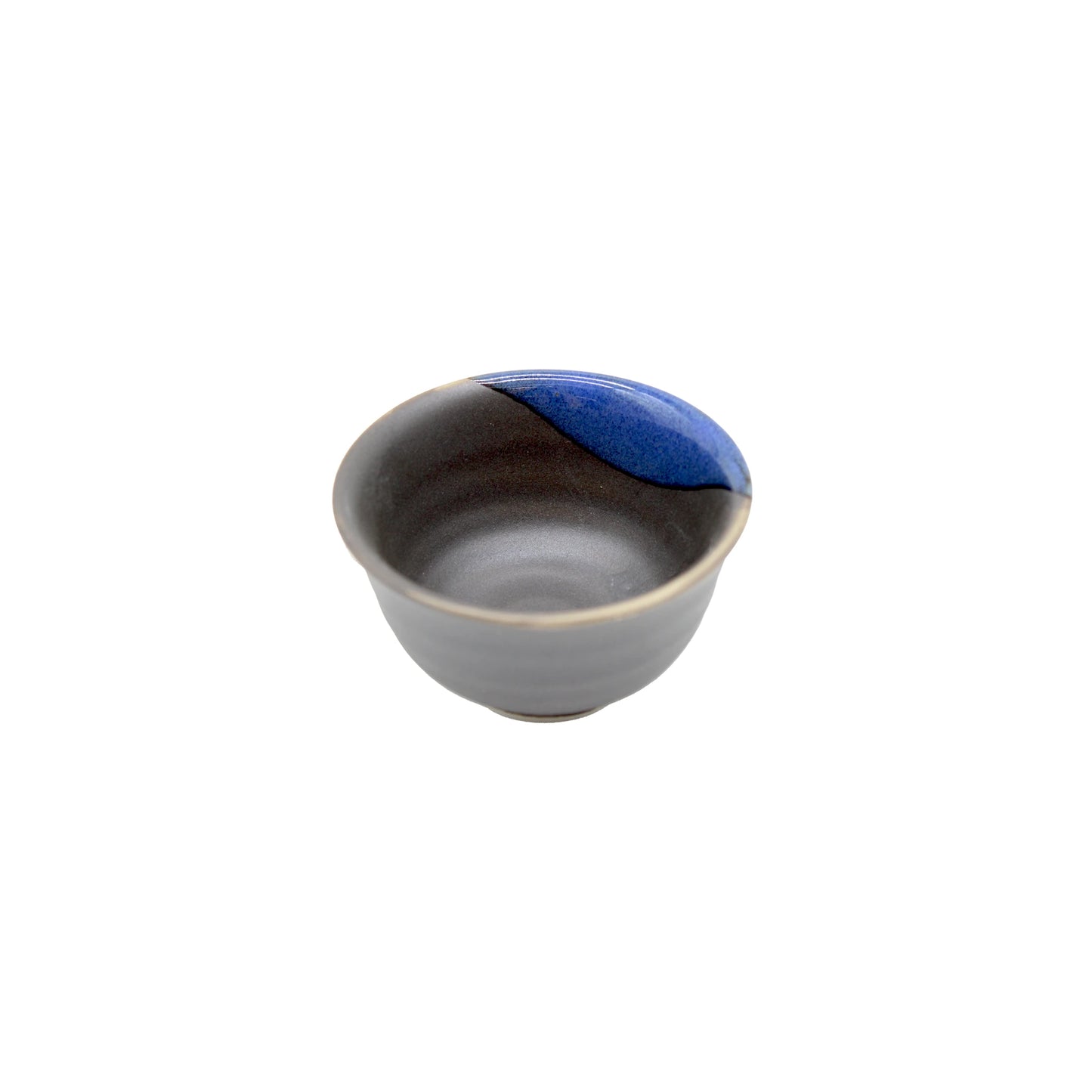 A Sake Cup - Black with Blue Glaze, showcasing a dark ceramic body and a striking blue accent on one rim, set against a white background—a refined tribute to Japanese craftsmanship.