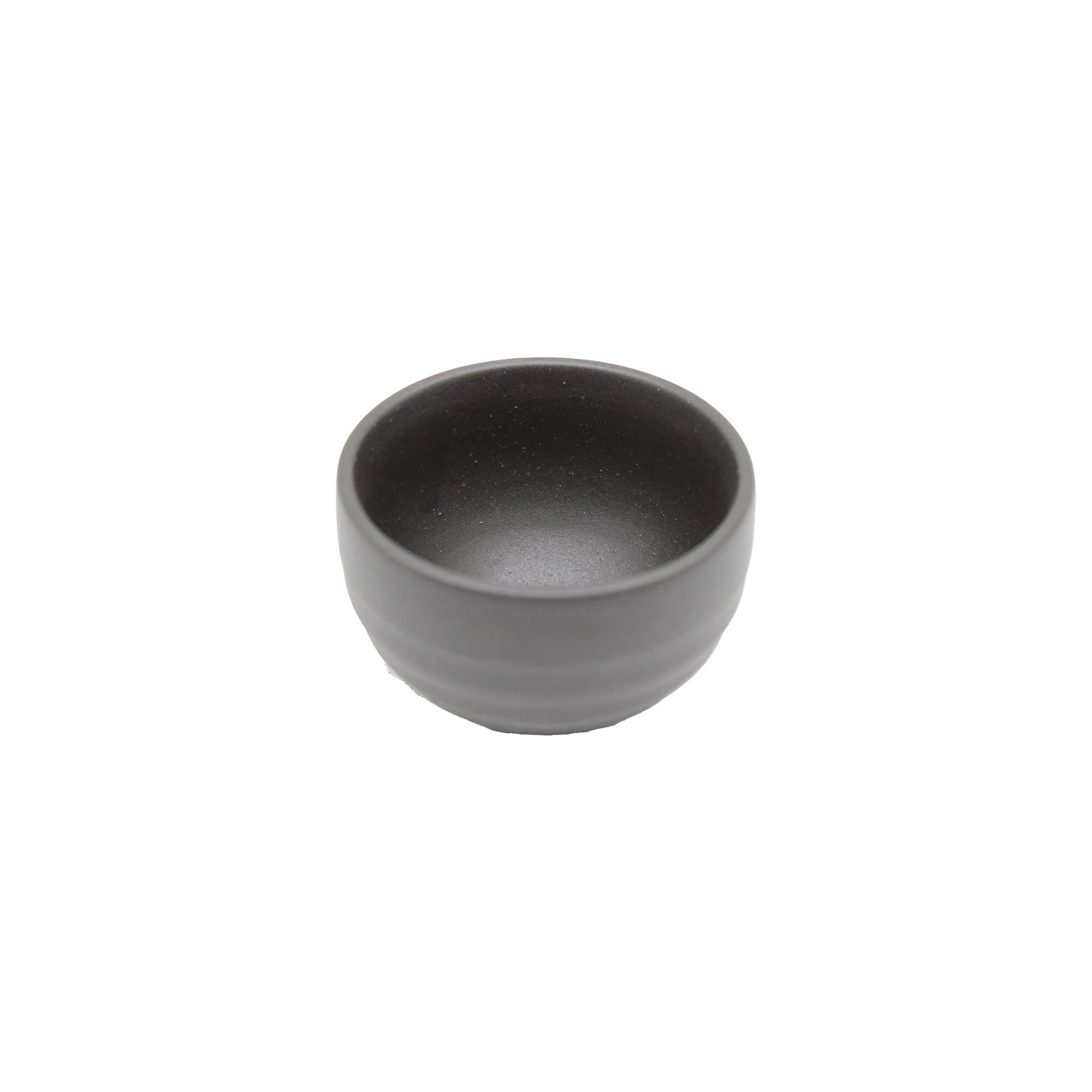 The Sake Cup - Black Bizen is a small, round, matte black ceramic bowl inspired by traditional Japanese pottery and classic Black Bizen ware, shown here on a white background.