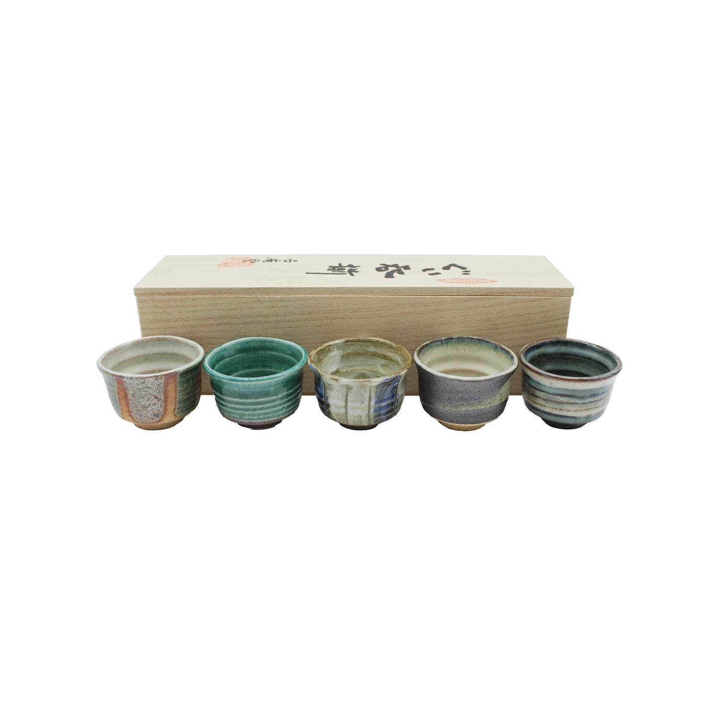 The Ochoko Sake Cups - Set of 5 features five uniquely colored and patterned cups arranged before a rectangular wooden box with Japanese writing, showcasing the elegance of Japanese ceramic artistry.