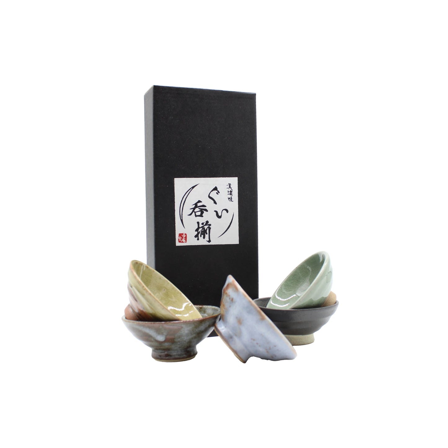 The Sakazuki Flat Sake Cups - Set of 5 features five small Japanese sake cups in earthy tones, beautifully arranged before a black box with calligraphy—ideal for ceremonial drinking or as a unique gift.
