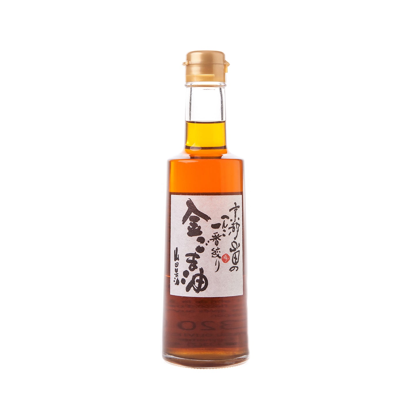 A 300ml glass bottle of Gold Sesame Oil with a cork cap and black-and-red Japanese label, crafted by the Yamada Seiyu family using traditional wood-fired ovens.