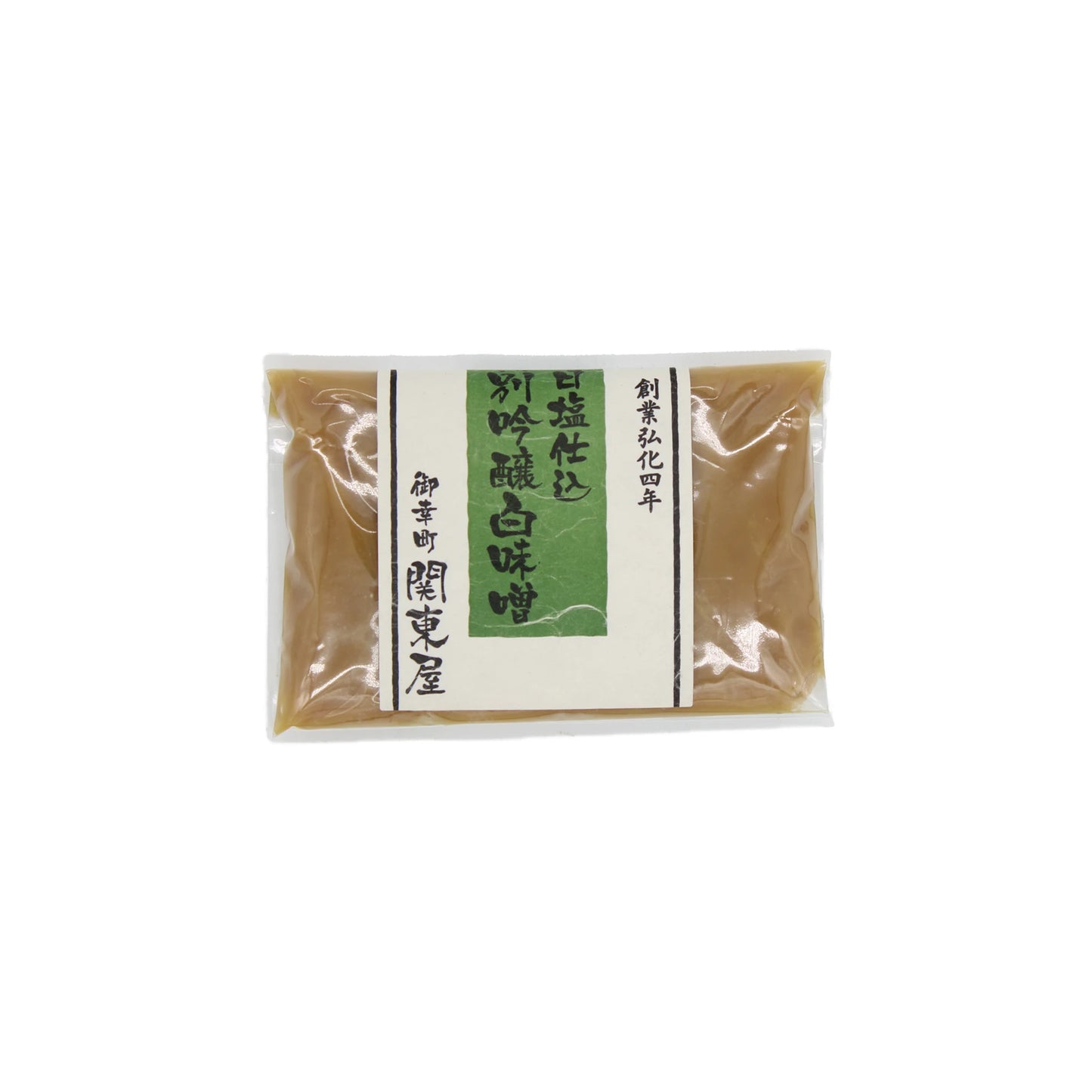 A sealed plastic pouch of Shiro White Miso, a staple in Japanese cuisine, with a green and white label displaying Japanese text—showcasing the art of fermentation.