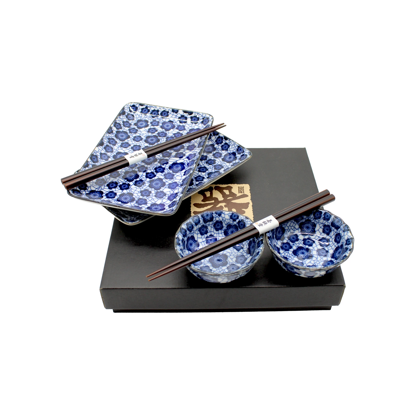 The Sushi Gift Set in Blue Plum features a Japanese-inspired blue and white pattern with two rectangular plates, two small bowls, two pairs of chopsticks, and a black tray.