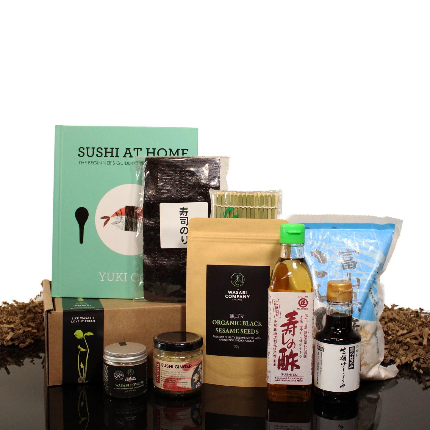 Discover the Sushi Starter Set with Sushi At Home Cook Book, complete with sushi rice, nori sheets, soy sauce, rice vinegar, sesame seeds, wasabi, and pickled ginger—ideal for making vegan sushi and more in your own kitchen.