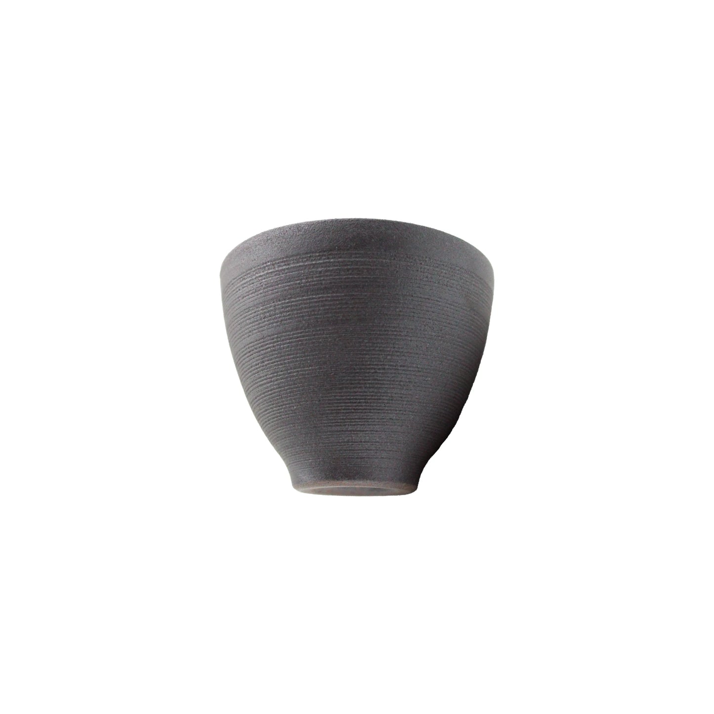The Tea Cup - Hasamiyaki Kurosendan Black is a small, matte gray teacup with a textured surface and slightly flared rim, shown on a white background.