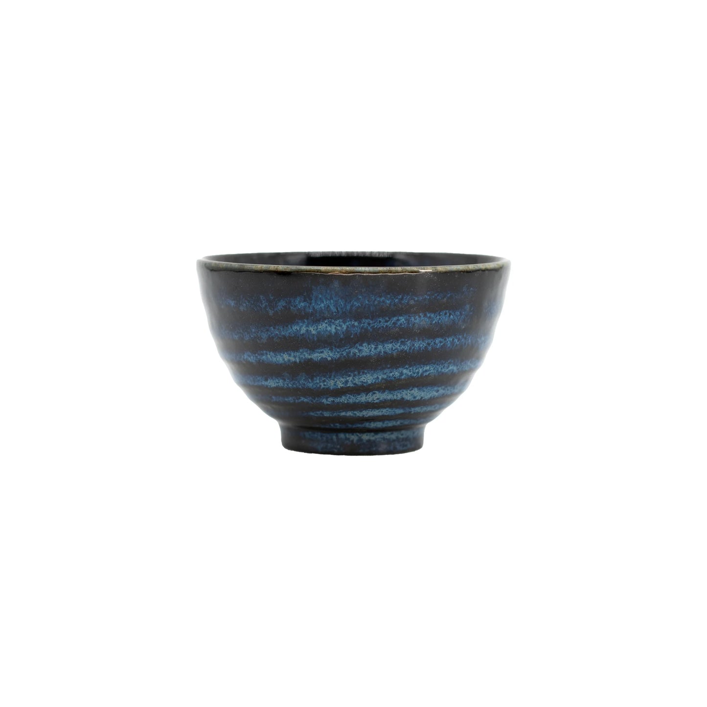 The Tea Cup - Indigo & Blue is a small Japanese ceramic piece featuring an indigo blue and black glaze, subtle horizontal ridges, and a slightly flared rim.