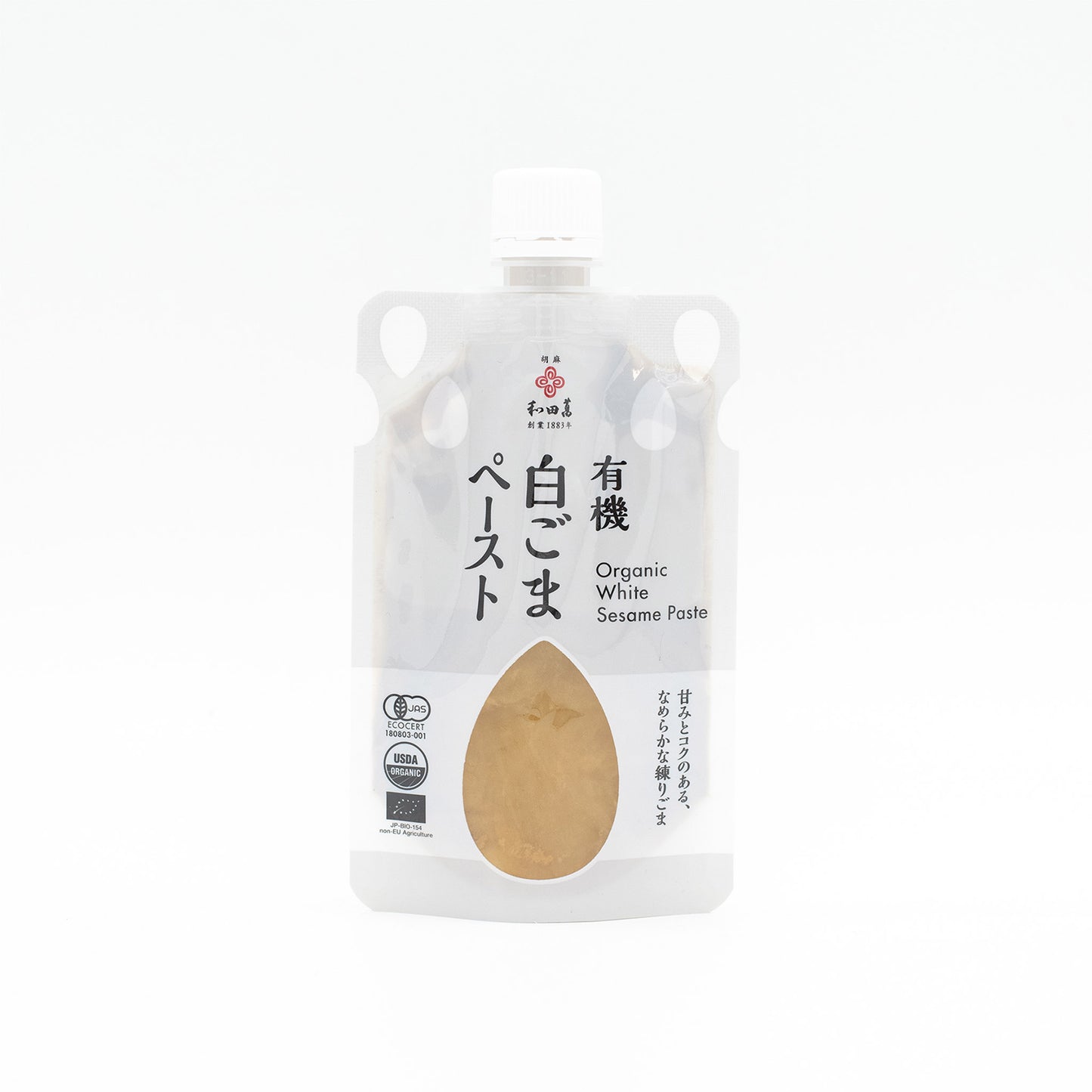 A clear pouch of Wadaman Organic White Sesame Paste with Japanese and English text on the label, a white cap, and USDA Organic certification.