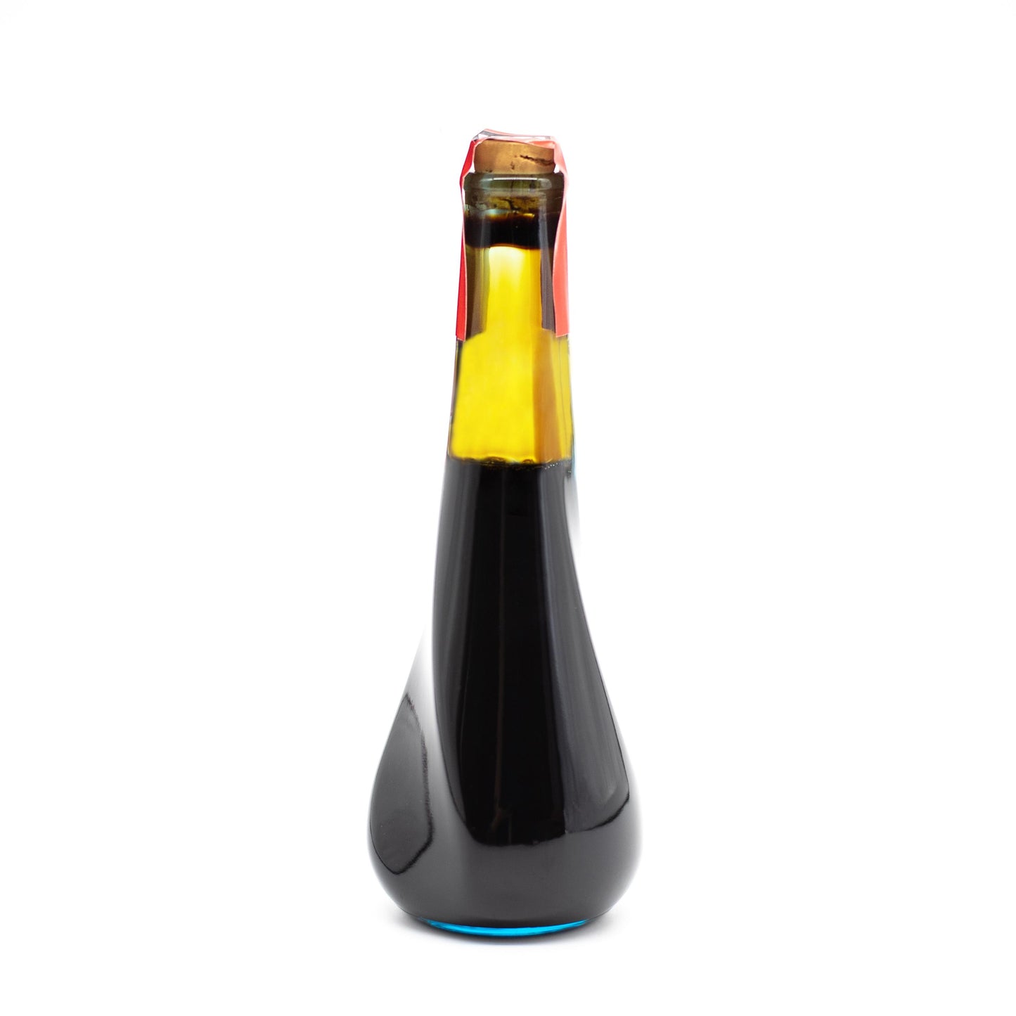 A clear glass bottle of 10 Year Aged Soy Sauce (180ml), filled with dark liquid and sealed with a cork and red wax, is displayed against a white background.