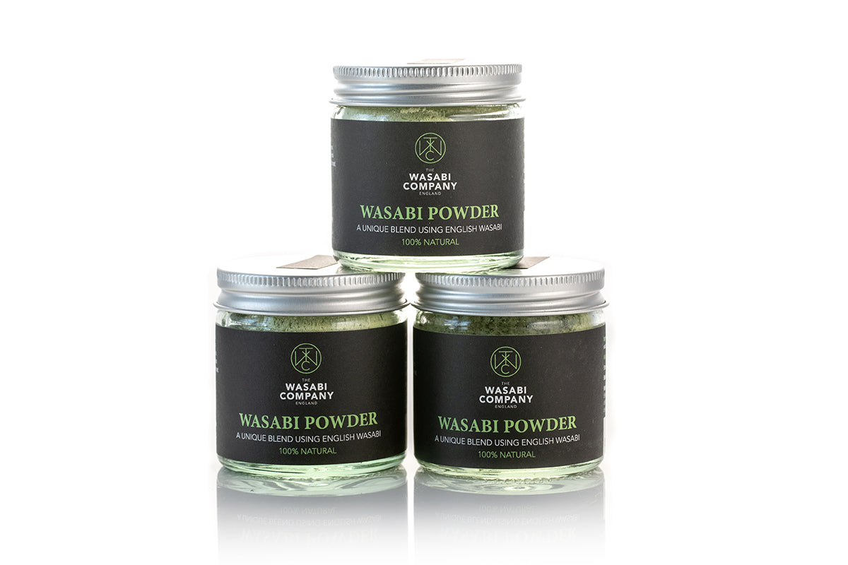 Three glass jars of Wasabi Powder - 23g are stacked in a pyramid, each labeled as 100% natural English wasabi, offering an authentic Japanese spicy taste.