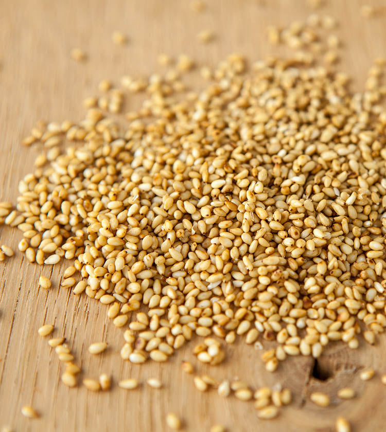 Sesame Seeds with Yuzu—roasted sesame seeds blended with hints of yuzu—are scattered across a wooden surface.
