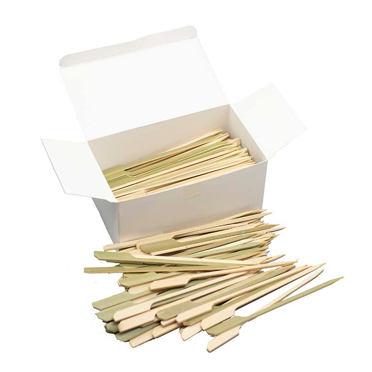 A white box of Teppo Gushi Bamboo Skewers (15cm) - 250 units, with skewers inside and some scattered in front—ideal for preparing food on Konro or Shichirin grills.