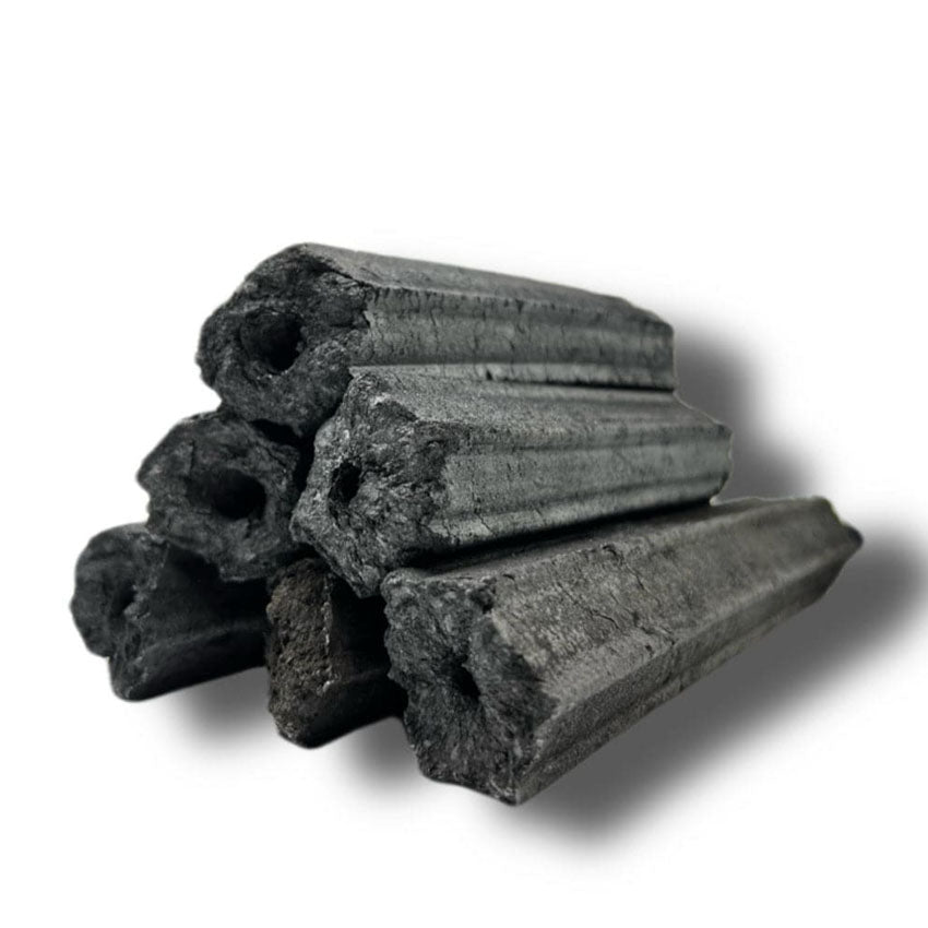 A stack of black, hexagonal, hollow Compressed Charcoal Briquettes arranged on a white background—ideal for use in Konro Grills.