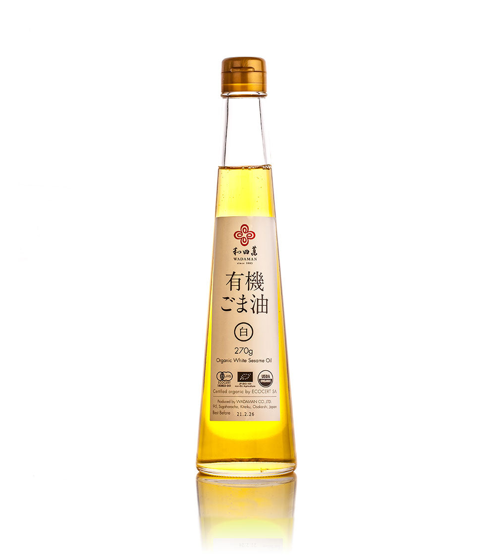Wadaman Organic White Sesame Oil comes in a clear glass bottle with a gold cap and Japanese text on the label—high-quality oil crafted by master roaster Etsuji Wada, perfect for drizzling over sashimi.