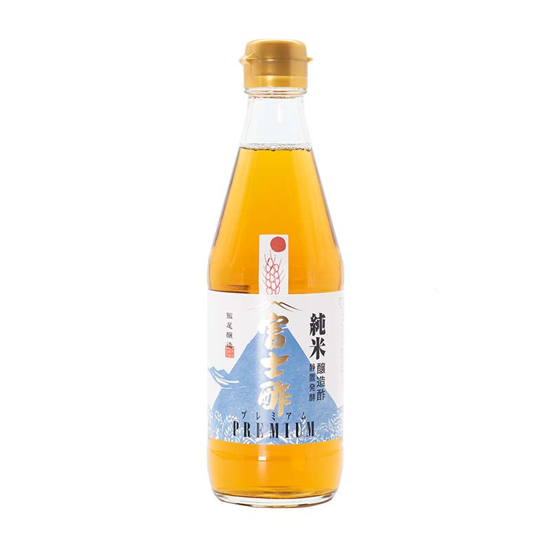 Premium Fujisu Rice Vinegar comes in a clear glass bottle filled with golden liquid, sporting a white and blue Japanese label with illustrations and a gold cap; traditionally fermented for rich umami flavor.