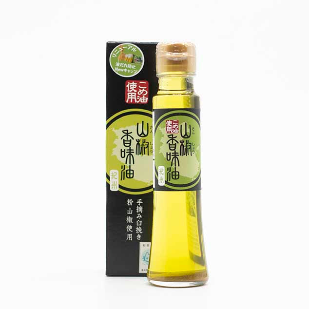 A 107ml bottle of Green Sansho Oil with green labeling is shown in front of its matching box, both with Japanese text—a flavorful addition to Japanese dishes.
