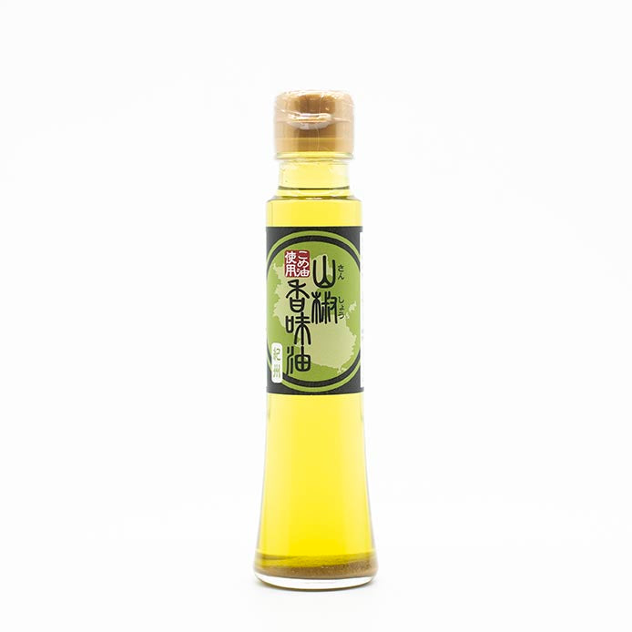 A clear glass bottle of Green Sansho Oil (107ml) with a green and black label featuring Asian characters and a tan cap sits on a white background—ideal for adding authentic sansho pepper oil flavor to Japanese dishes.
