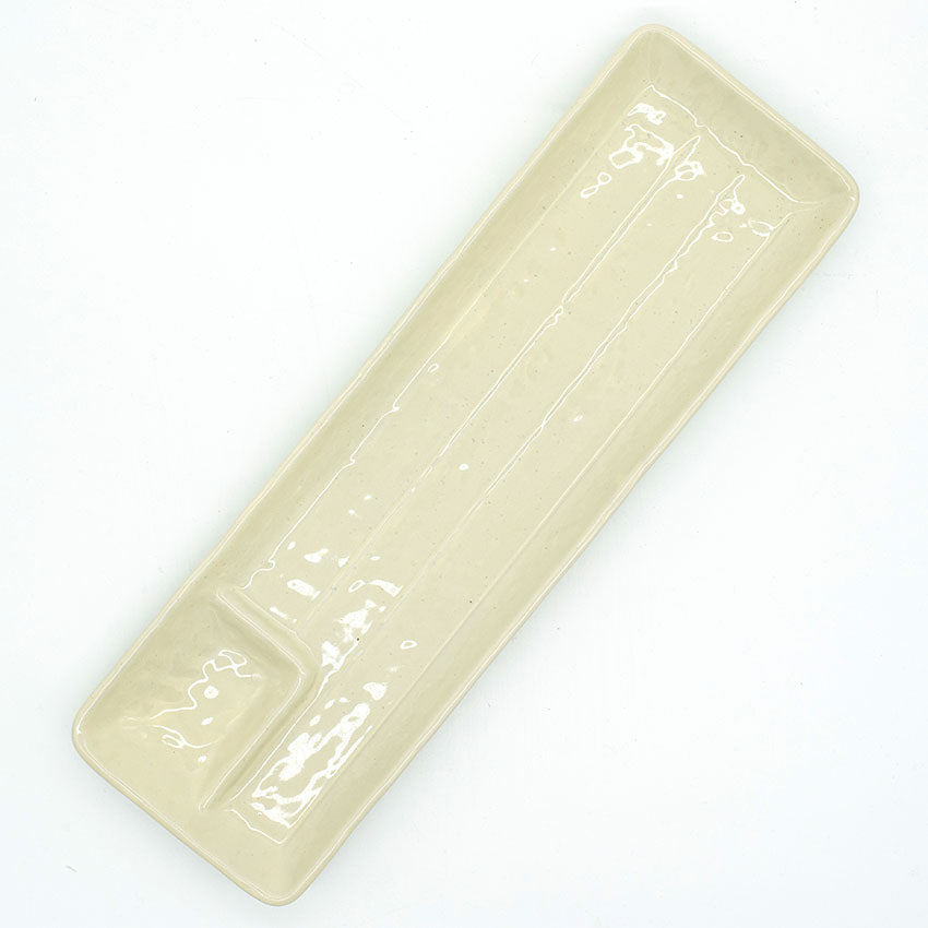Gyoza Plate in Ivory with Built-in Sauce Dish—a rectangular cream-colored ceramic plate with a glossy finish and minimalist design, featuring an indented corner for sauce.