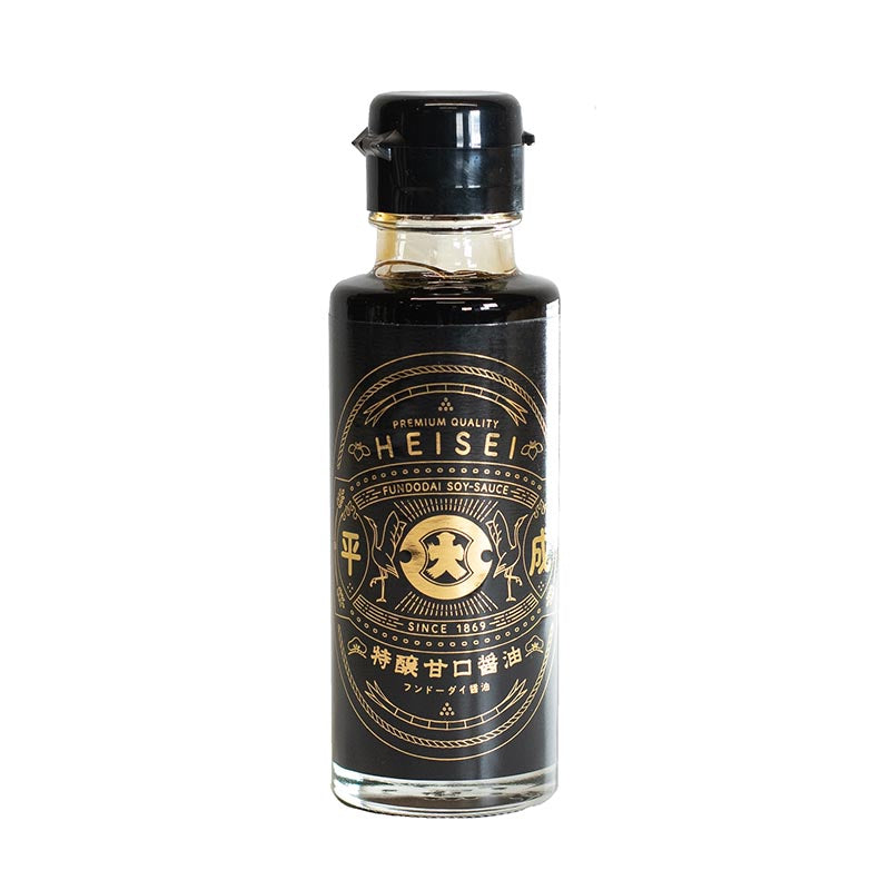 Heisei Shoyu Soy Sauce - 100ml comes in a clear glass bottle with a black cap and an elegant black and gold label, offering the signature sweetness of Heisei Era Sweet Soy Sauce by Fundodai.
