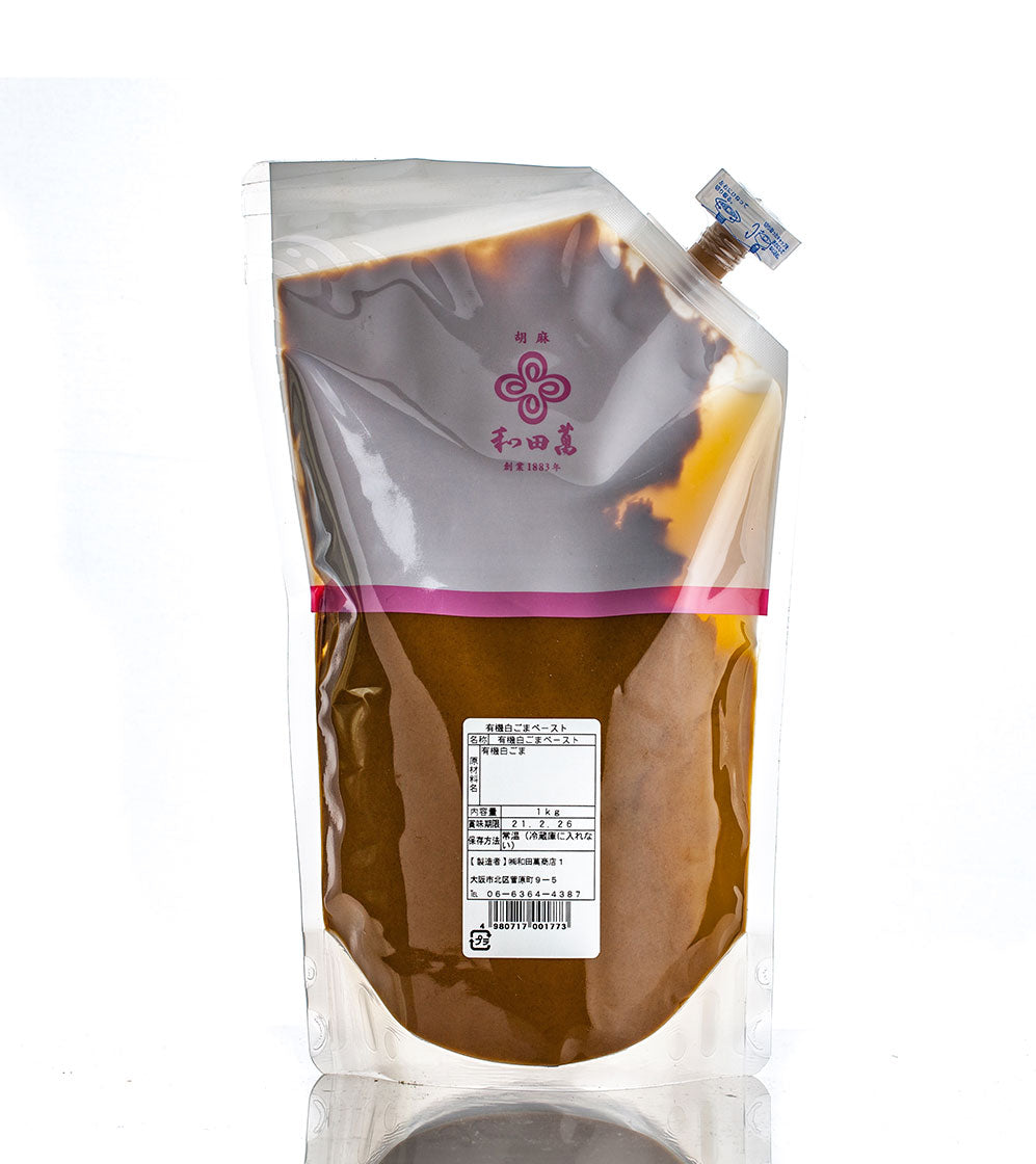 A clear pouch with a screw cap, filled with brown liquid and labeled in Japanese, holds Wadaman Organic White Sesame Paste—ideal for storing rich sesame flavor.