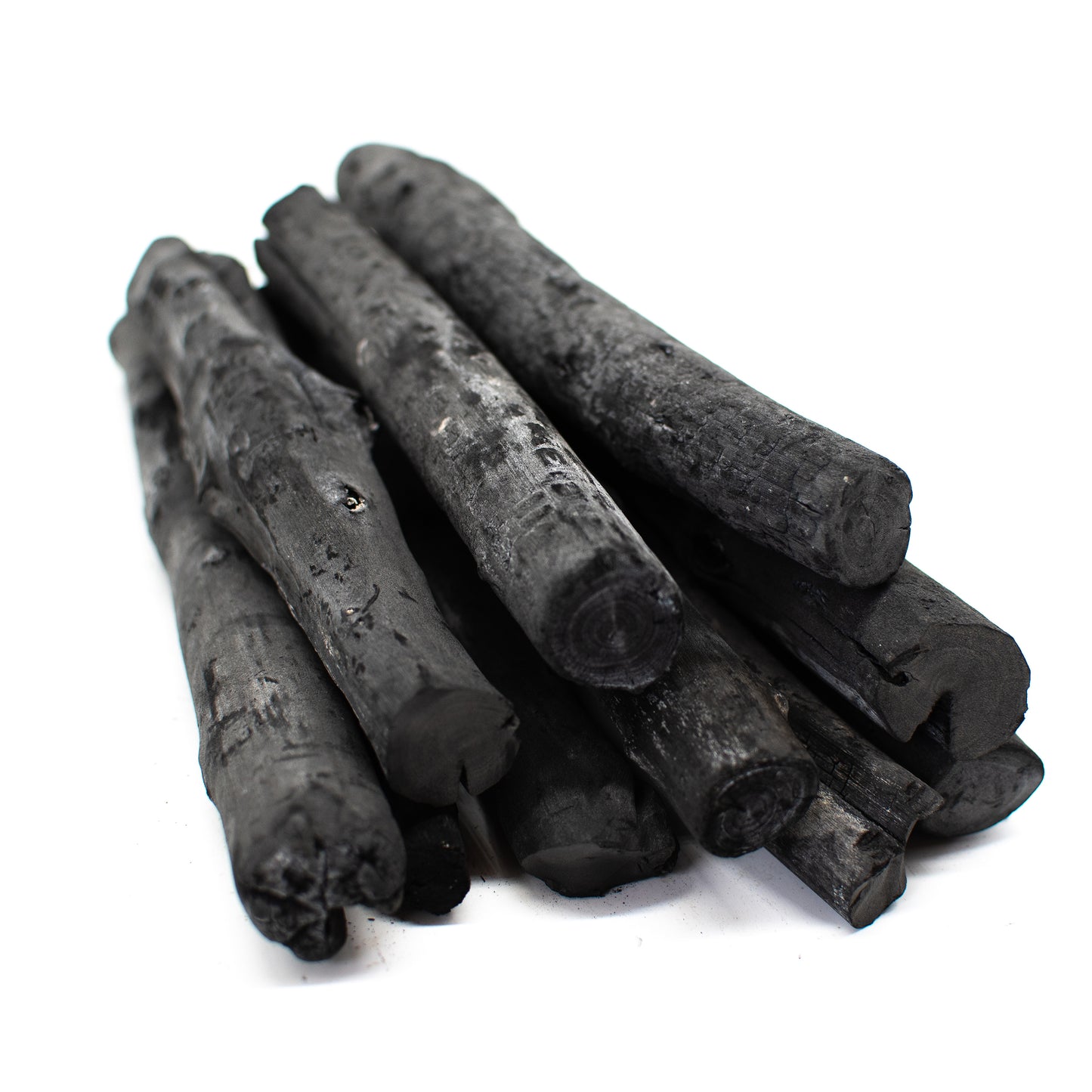 Several pieces of Binchotan Komaru charcoal from Laos (1kg), crafted using traditional Japanese techniques, are stacked together on a white background.