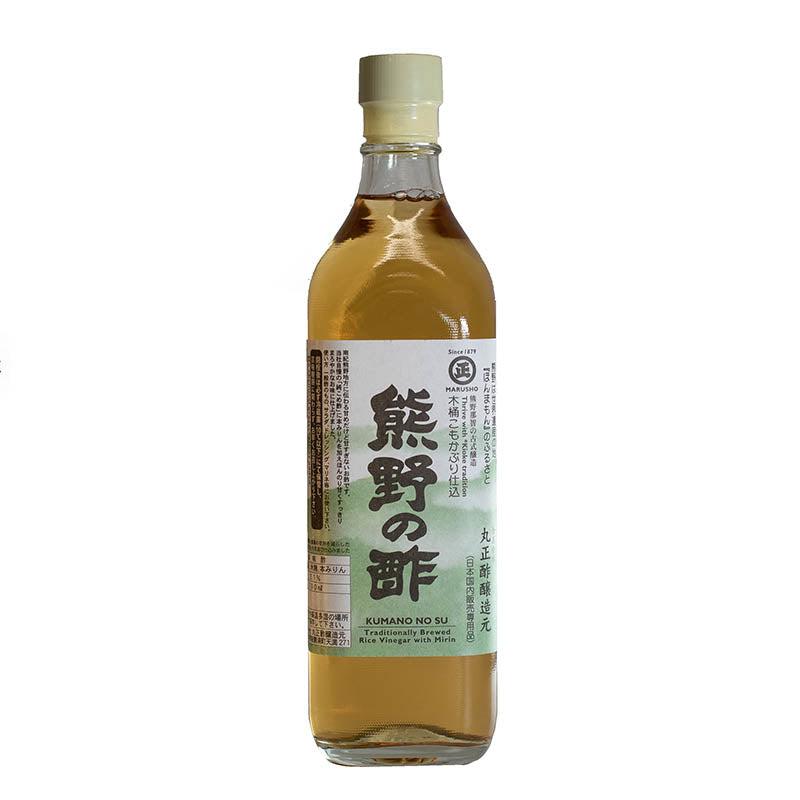 A clear glass bottle labeled “Kumano No Su, Rice Vinegar with Mirin” features Japanese text and a green-white label—ideal for seasoning sushi rice or enhancing dishes with depth and subtle sweetness.