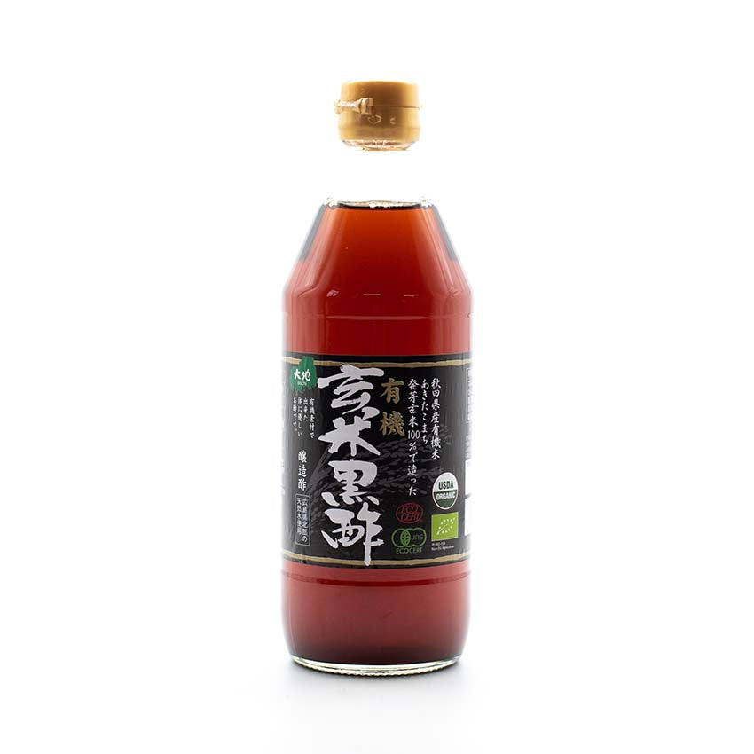 A 500ml bottle of Organic Brown Rice Vinegar, all natural Japanese black vinegar with a tan cap, black label with Japanese text and certification logos, offering rich umami flavor.