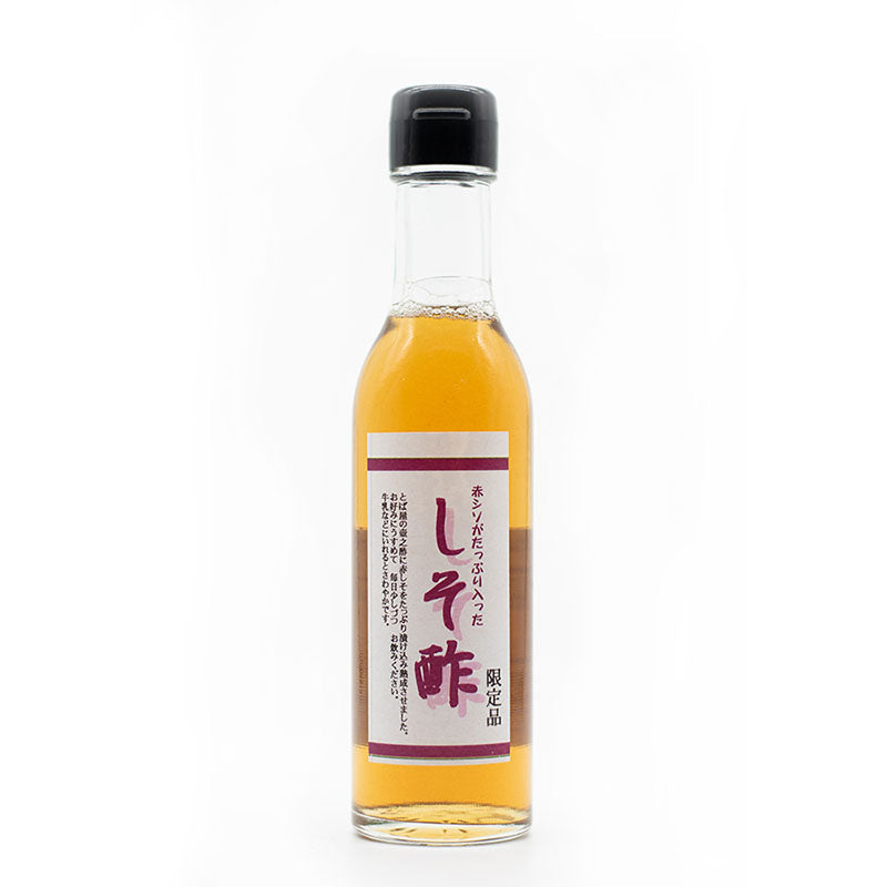 A clear glass bottle of Red Shiso Rice Vinegar 180ml, with a purple and white Japanese label, stands upright against a white background— inspired by master vinegar maker Nakano San.