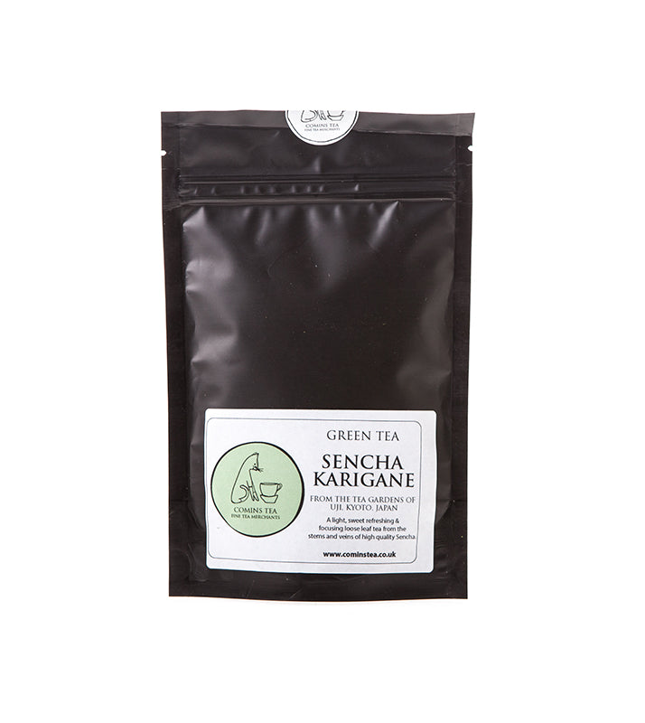 A black resealable pouch labeled Sencha Karigane Tea - 50g from Uji, Kyoto, Japan, features a green and white Comins Tea sticker—ideal for enjoying a refreshing first flush tea experience.