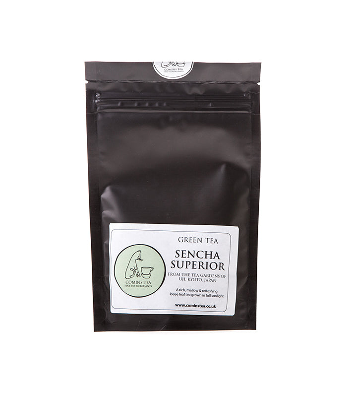 A black resealable pouch labeled Sencha Superior Tea - 50g from Comins Tea, featuring a white sticker with branding and details—this mellow tea offers a smooth, refreshing flavor ideal for those who enjoy a gentle cup.
