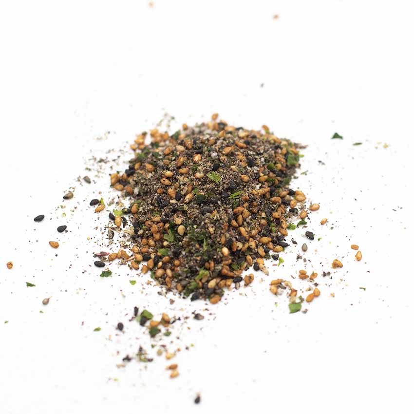 A small pile of Wadaman Furikake Sesame & Shiso (30g), featuring black sesame seeds, shiso, and green herbs, scattered on a white surface.