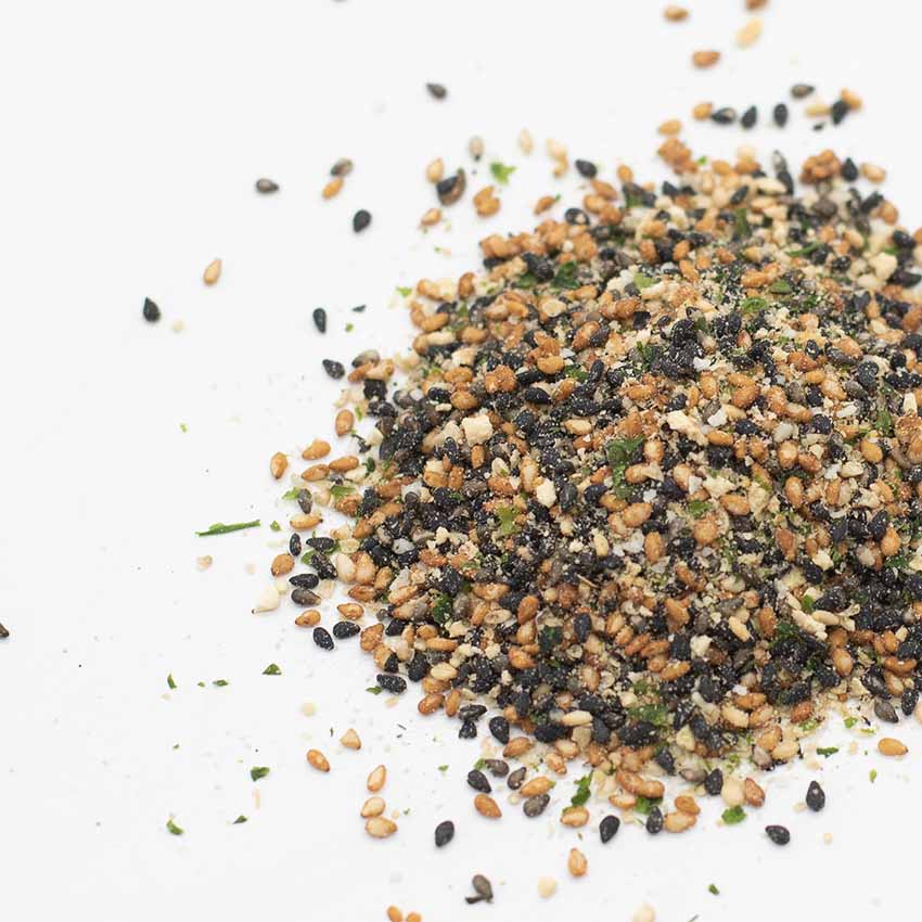 Wadaman Furikake Sesame & Yuzu 25g is shown in a pile with visible sesame seeds, seaweed flakes, and other small dried ingredients scattered on a white background.