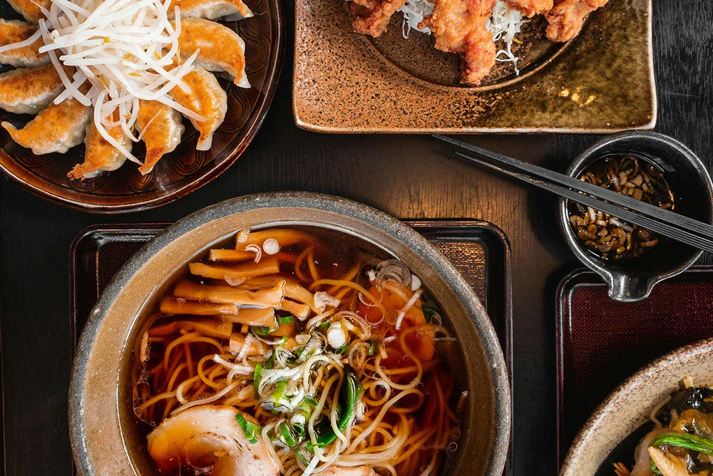 Selection of Japanese dishes including noodle soup, gyozas and katsu curry