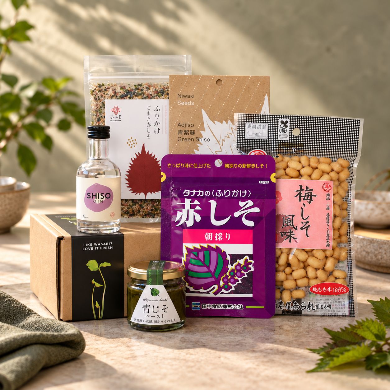 
                  
                    Shiso Lovers Gift Set containing a small bottle of gin, a jar of green shiso paste, and various packs of Japanese shiso seeds and crunchy snacks.
                  
                