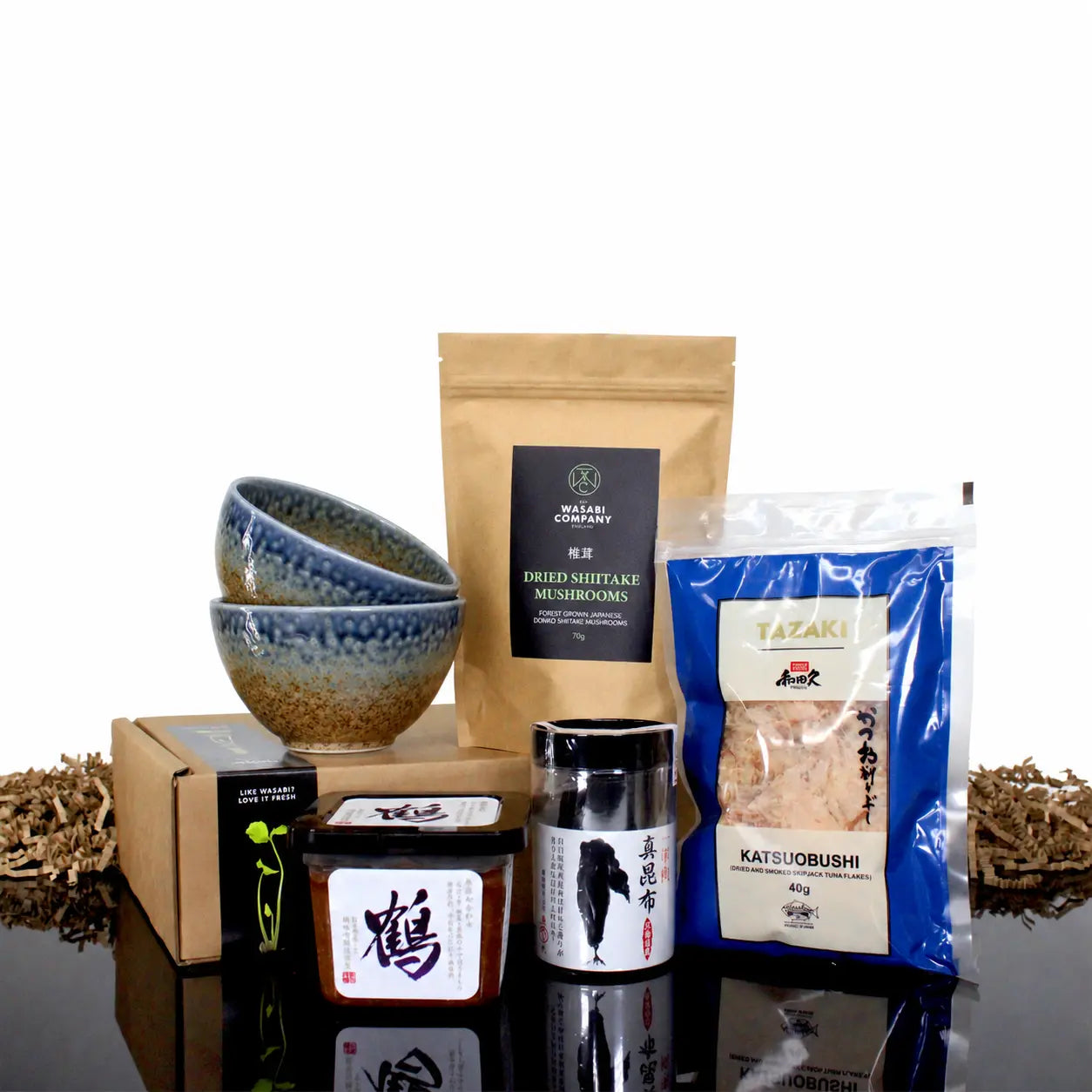 Miso Soup Kit with Miso Bowls containing two ceramic bowls, dried shiitake mushrooms, katsuobushi, Japanese miso paste, and dried seaweed.
