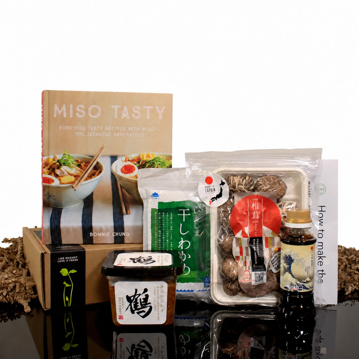 
                  
                    Miso Soup Kit with Miso Tasty Cook Book, including a cookbook, miso paste, dried mushrooms, sauce, and dried seaweed.
                  
                