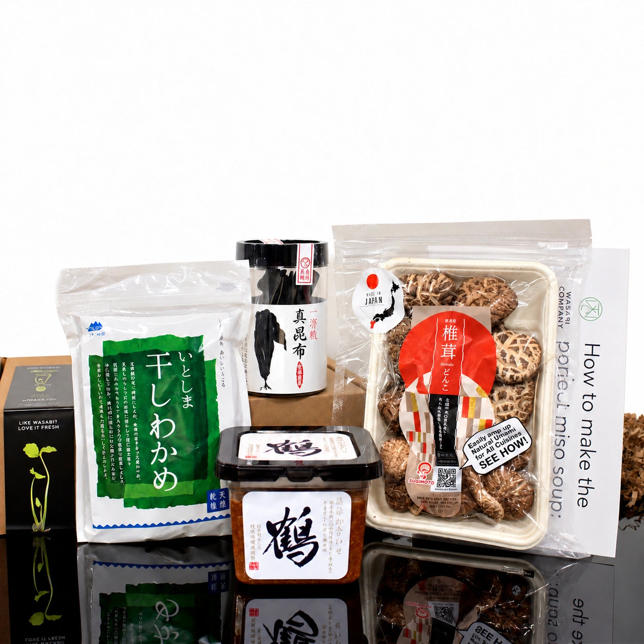 Vegan Miso Soup Kit containing dried seaweed, barley miso, dried shiitake mushrooms, a canister of kombu seaweed, and a recipe card.