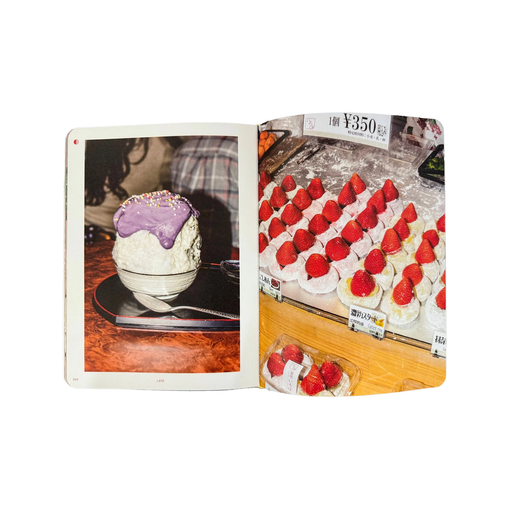 
                  
                    An open book, "A Day in Tokyo" by Brendan Liew & Caryn Ng, displays a purple dessert bowl on the left and strawberry-topped pastries with price tags on the right, highlighting exquisite Japanese cuisine.
                  
                