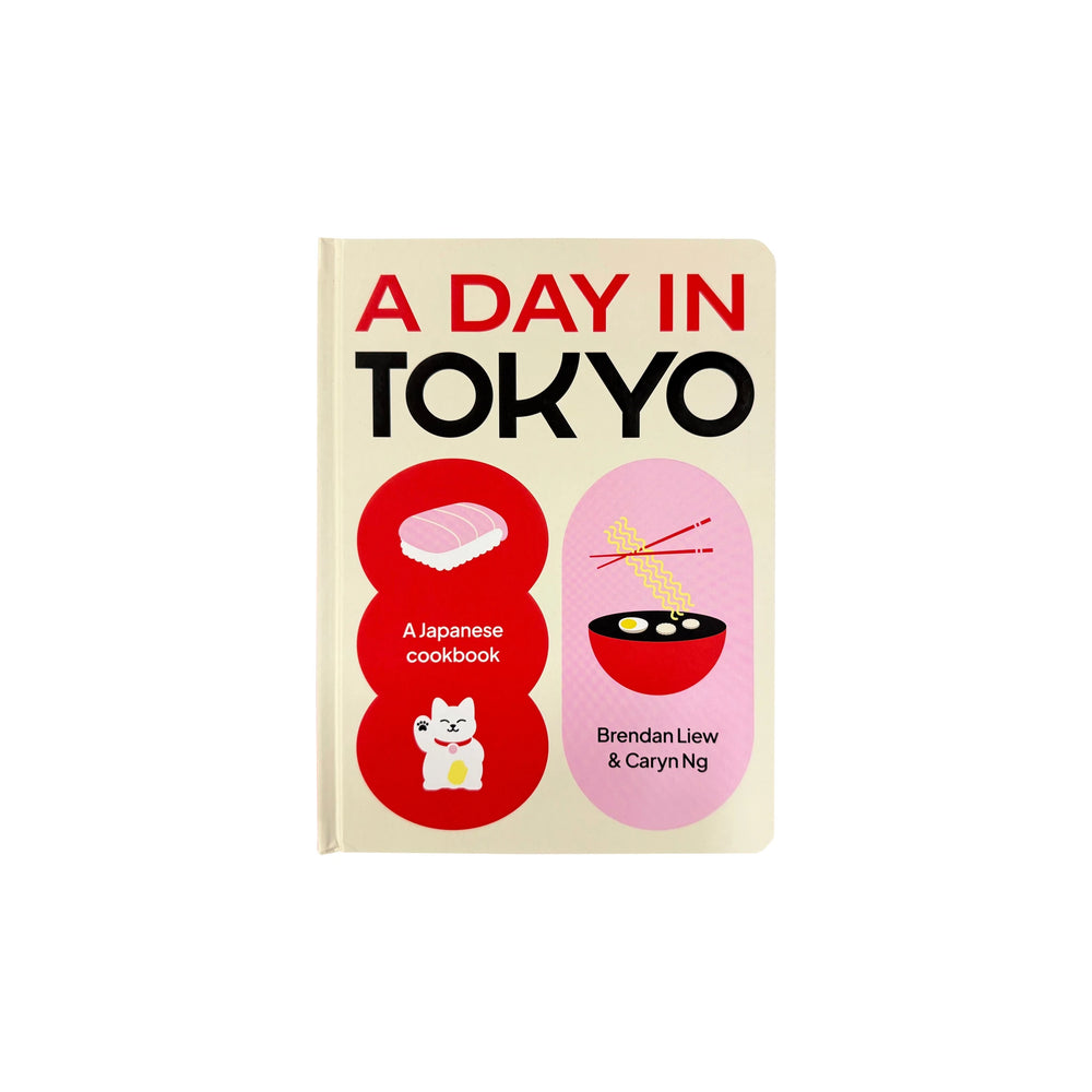 The front cover of "A Day in Tokyo by Brendan Liew & Caryn Ng" features sushi, ramen, a waving cat, and the authors’ names. The cookbook highlights vibrant Tokyo cuisine.