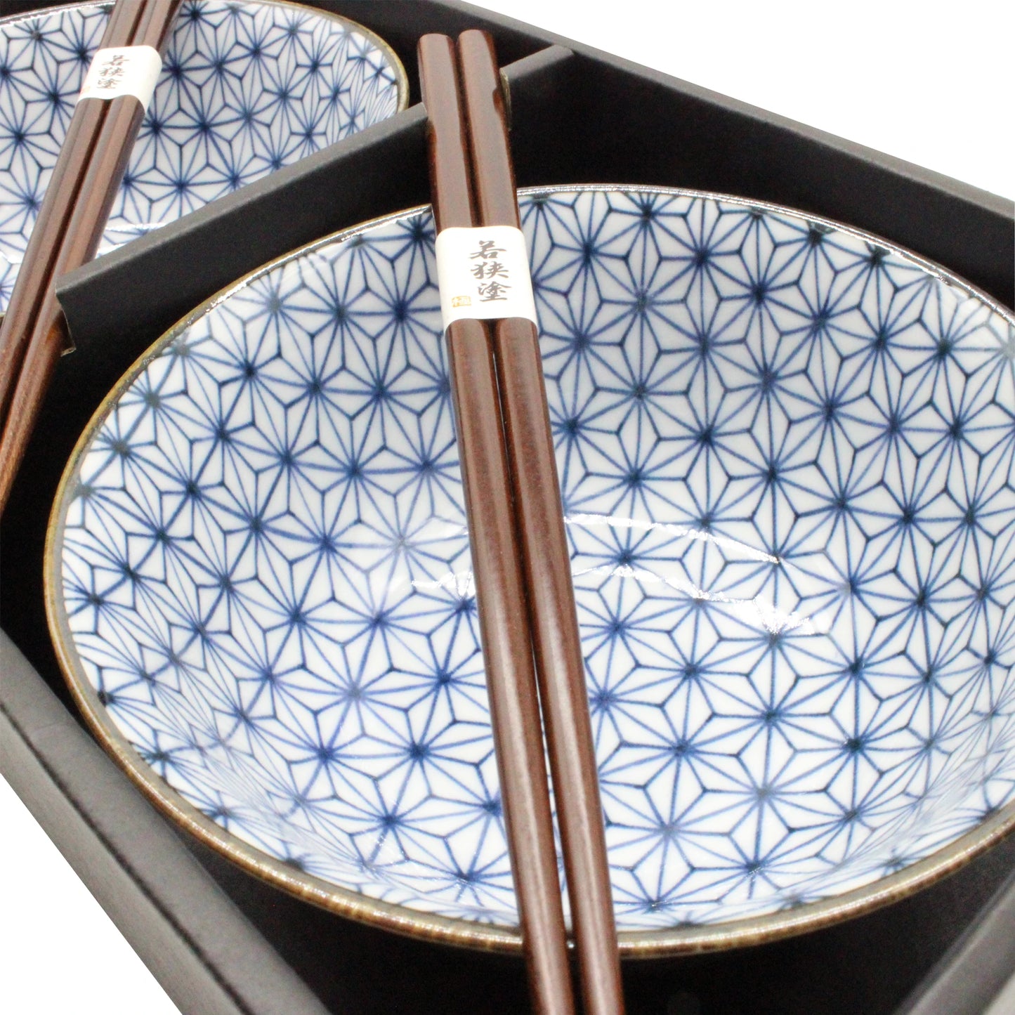 The Asanoha Bowls Gift Set - Blue & White includes two ceramic bowls with blue Asanoha patterns and wooden chopsticks, all elegantly arranged in a black box—perfect for a stylish ramen bowl set.