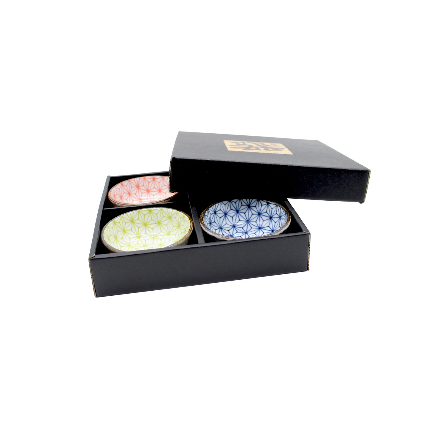 
                  
                    A partially open black box contains the Asanoha Design Sauce Dish Gift Set - 9cm, featuring three small Minoyaki ceramic plates with red, green, and blue geometric patterns.
                  
                