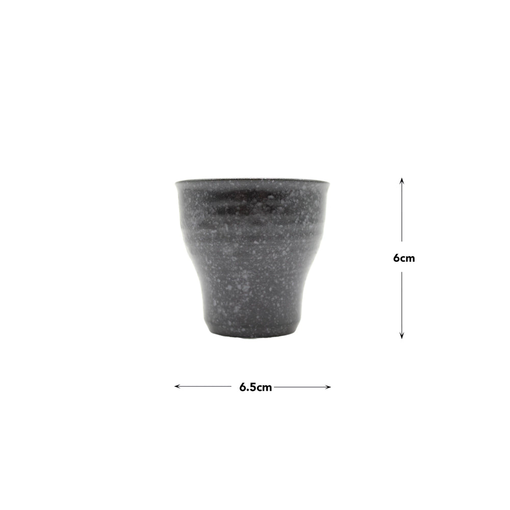 The Tea Cup - Black Fluted, an artisan porcelain teacup with dark speckles, measures 6 cm high and 6.5 cm wide. It is displayed on a white background with measurement arrows.