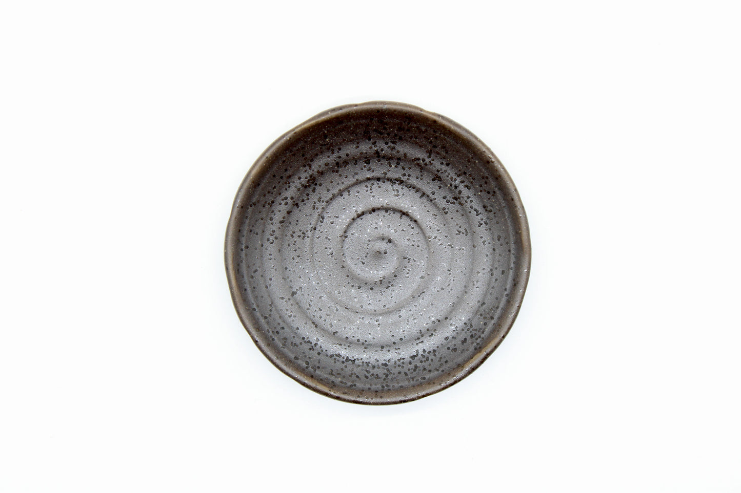 
                  
                    The Soy Sauce Dish - Black Iga Vortex features a gray spiral pattern inspired by the Iga vortex and a speckled ceramic texture, displayed on a plain white background.
                  
                