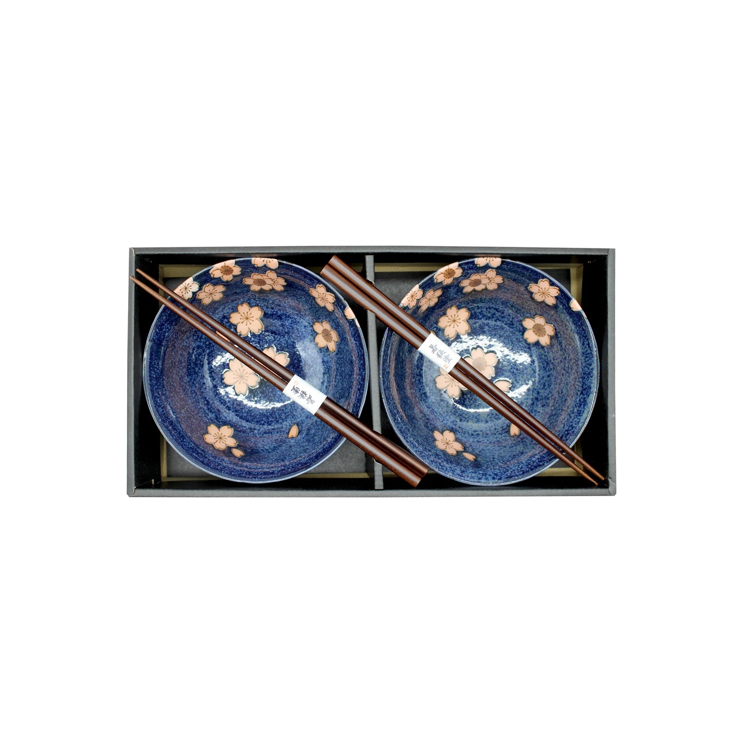 
                  
                    The Cherry Blossom Bowls Boxed Set - Blue with Pink Sakura features two Mino ware bowls with pink sakura patterns and two sets of wooden chopsticks, beautifully arranged side by side.
                  
                